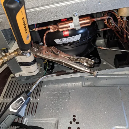 Genuine LG linear compressor during a sealed-system repair