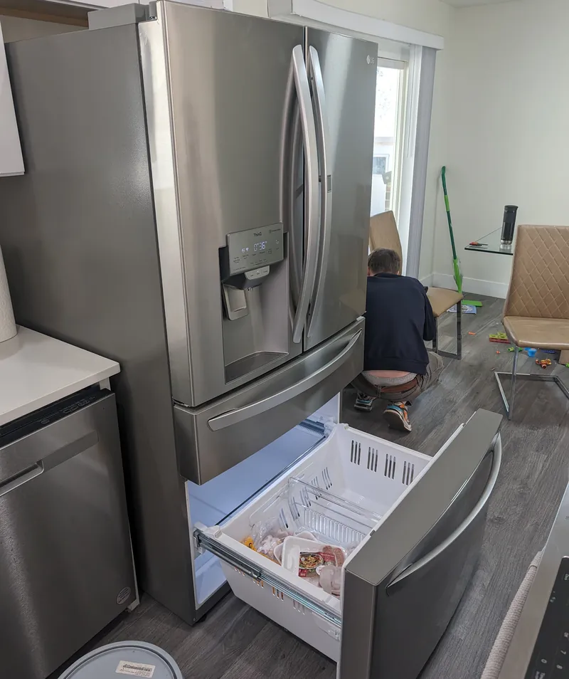 Best Pro technician repairing the cooling system of an LG French-door refrigerator